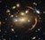 Galaksehobe, som MACSJ0138.0-2155 her, kan forstørre og forvrænge billedet af en fjern galakse, og gør astronomer i stand til at studere den meget detaljeret. (Illustration:  ESA/NASA/Hubble, A. Newman/M. Akhshik/K. Whitaker)